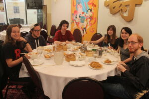 Students Gathered Around a Table For a Meal