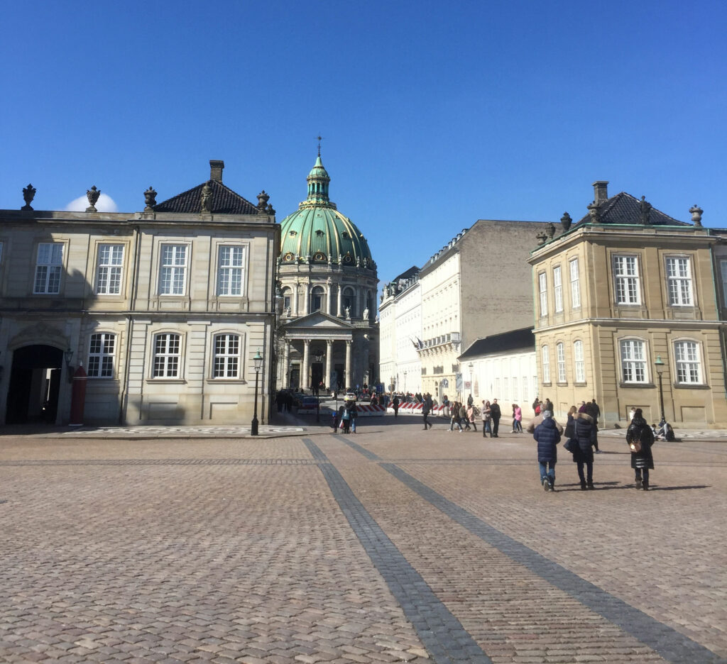 Amalienborg Palace in Copenhagen where the Danish royal family lives is a square with four mansions on it. The fancy dome in this photo isn’t even part of the palace; it’s the Marble Church.