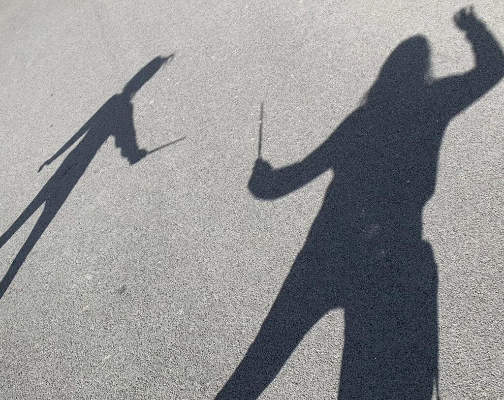 Photo: Two students' shadows battle wand-to-wand. Taken by Samantha Gougher